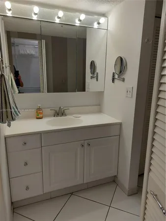 a white toilet sitting next to a shower