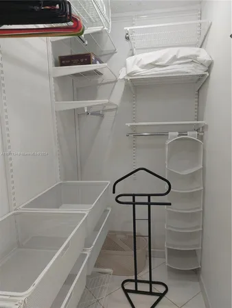 a view of a balcony with furniture and a floor to ceiling window