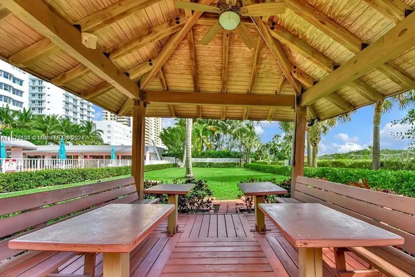 a view of a park with furniture and a fire pit