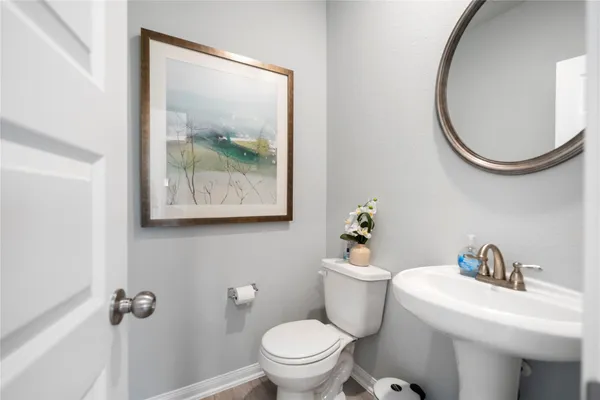 a white toilet sitting next to a bathroom sink