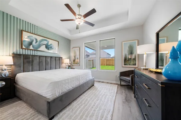 a spacious bedroom with a bed and a large window