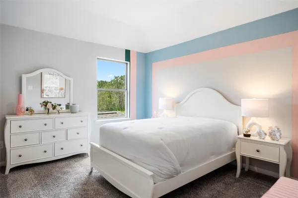 a bedroom with a bed and a dresser