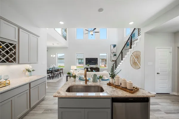 a kitchen with kitchen island a sink and a stove with wooden floor