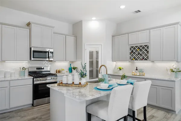a kitchen with a sink stove and microwave