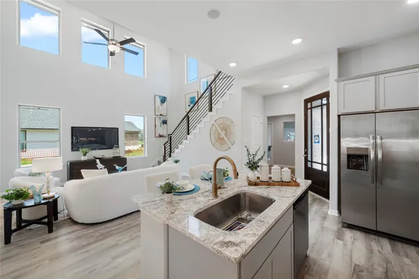 a kitchen with sink refrigerator and microwave