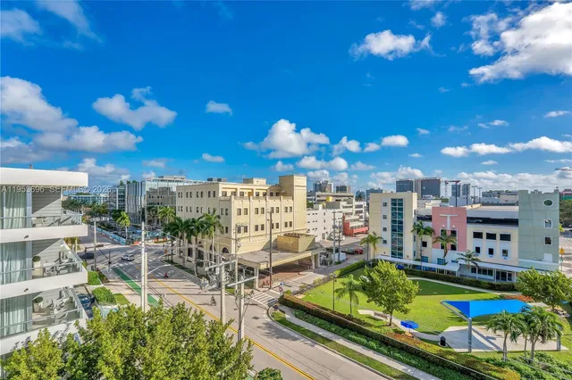 a view of a swimming pool with a patio and a yard