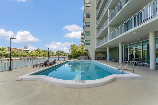 a view of a lake with boats and palm trees