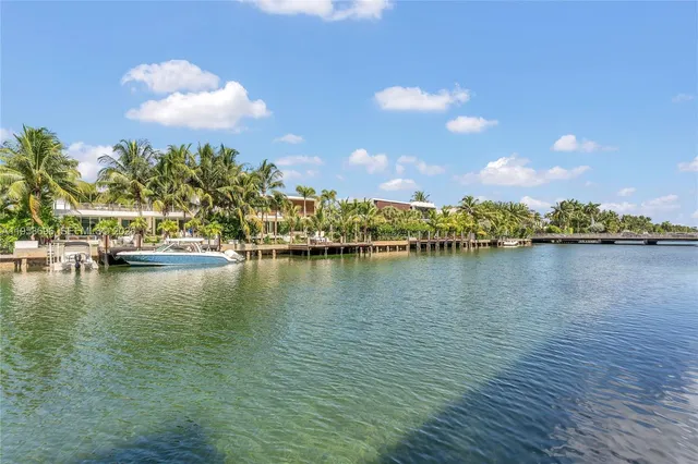 a view of a city that has tall buildings and cars parked