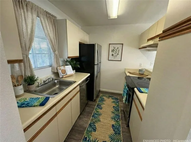 a kitchen with sink and refrigerator