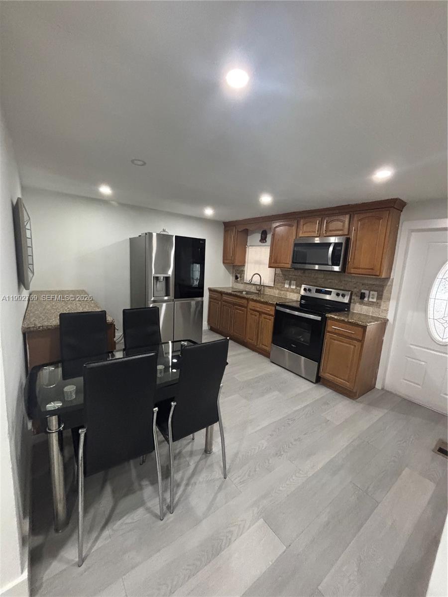 12888 Southwest 17th Street Miami, FL 33175 - Photo 16 of 19 a kitchen with a sink stainless steel appliances and furniture