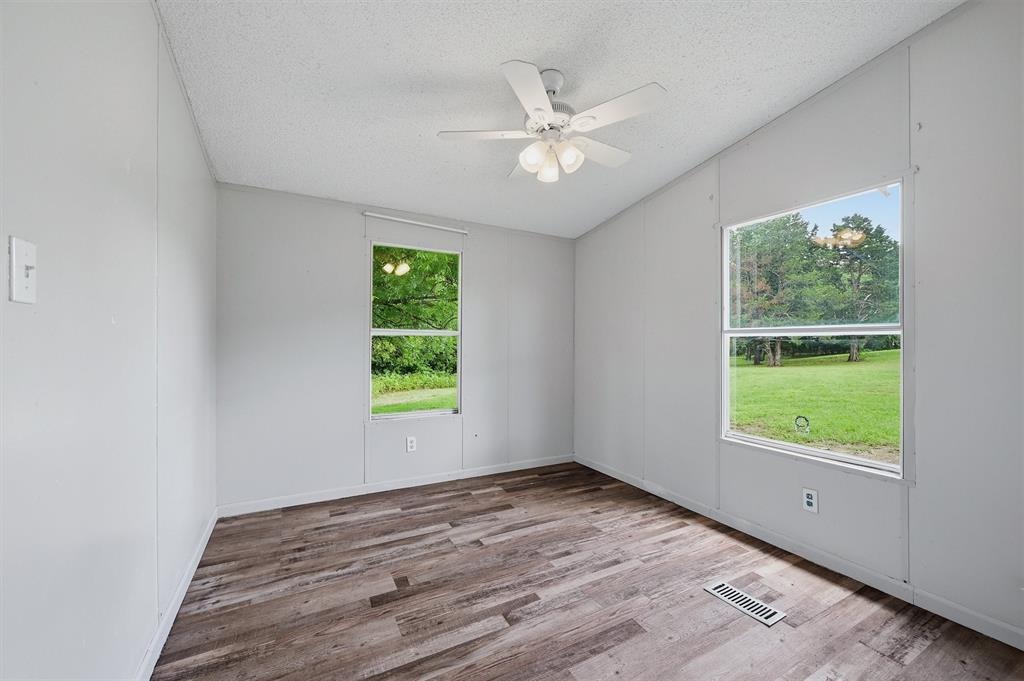 150 Gilbreath Road Sadler, TX 76264 - Photo 20 of 34 a view of an empty room with wooden floor and a window