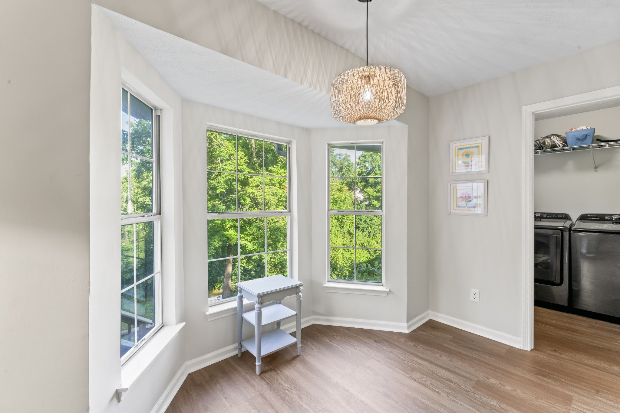 829 Bishopsgate Road Antioch, TN 37013 - Photo 11 of 18 a dining room with wooden floor a chandelier a wooden table and chairs