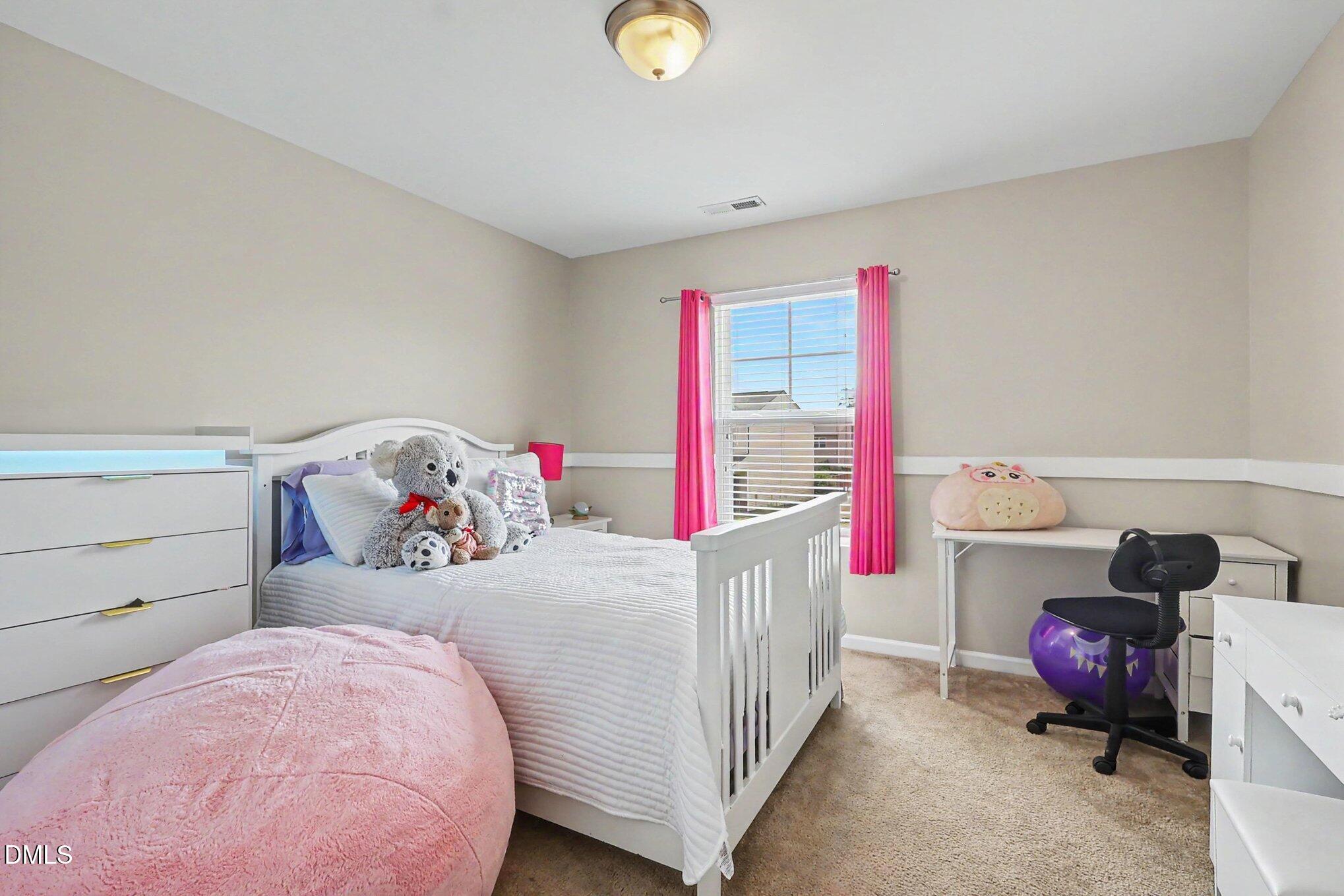 4366 Auburn Hills Drive Raleigh, NC 27616 - Photo 18 of 40 a bedroom with furniture and a baby crib