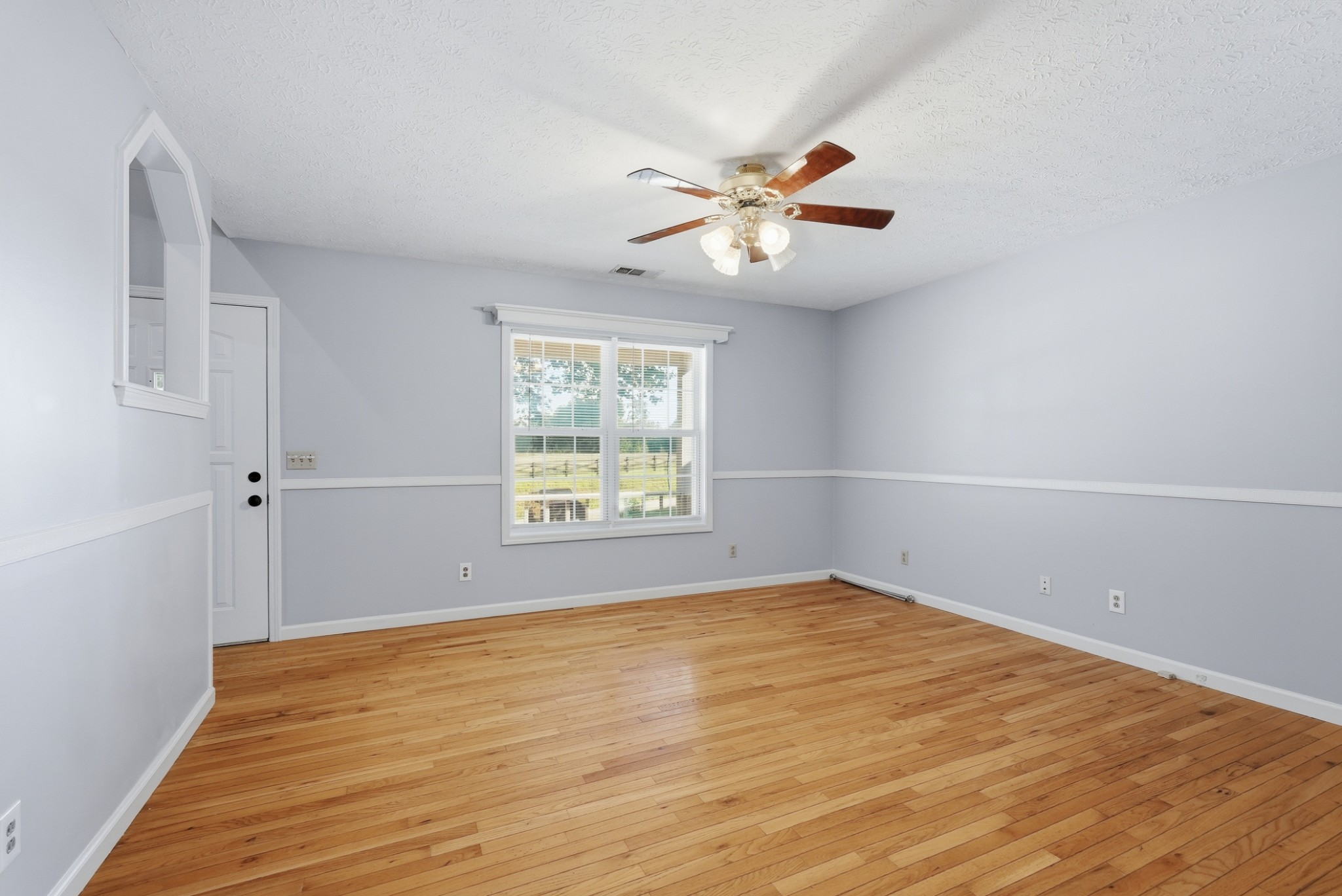 4877 Swafford Road Cookeville, TN 38501 - Photo 26 of 28 an empty room with wooden floor fan and windows