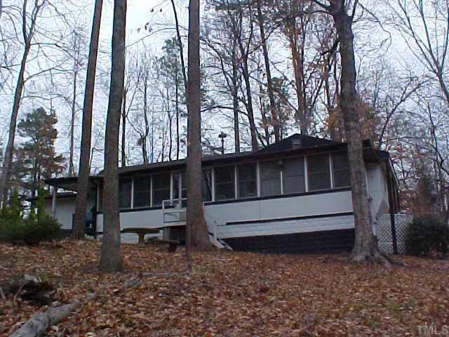 281 Kerr Lake Road Henderson, NC 27537 - Photo 1 of 5 a house with trees in front of it
