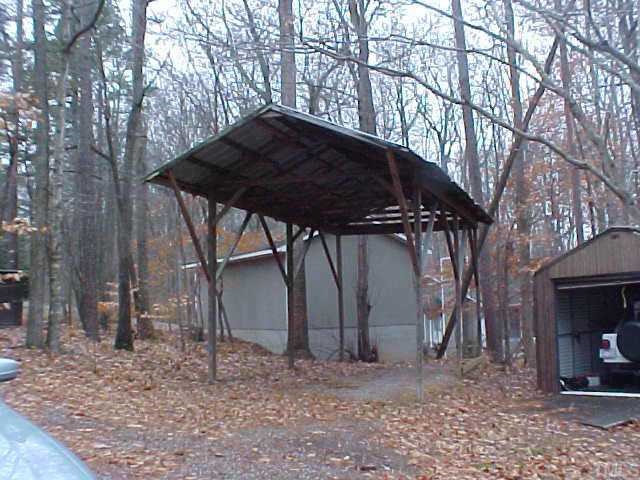 281 Kerr Lake Road Henderson, NC 27537 - Photo 2 of 5 a view of a backyard with large trees and a barn