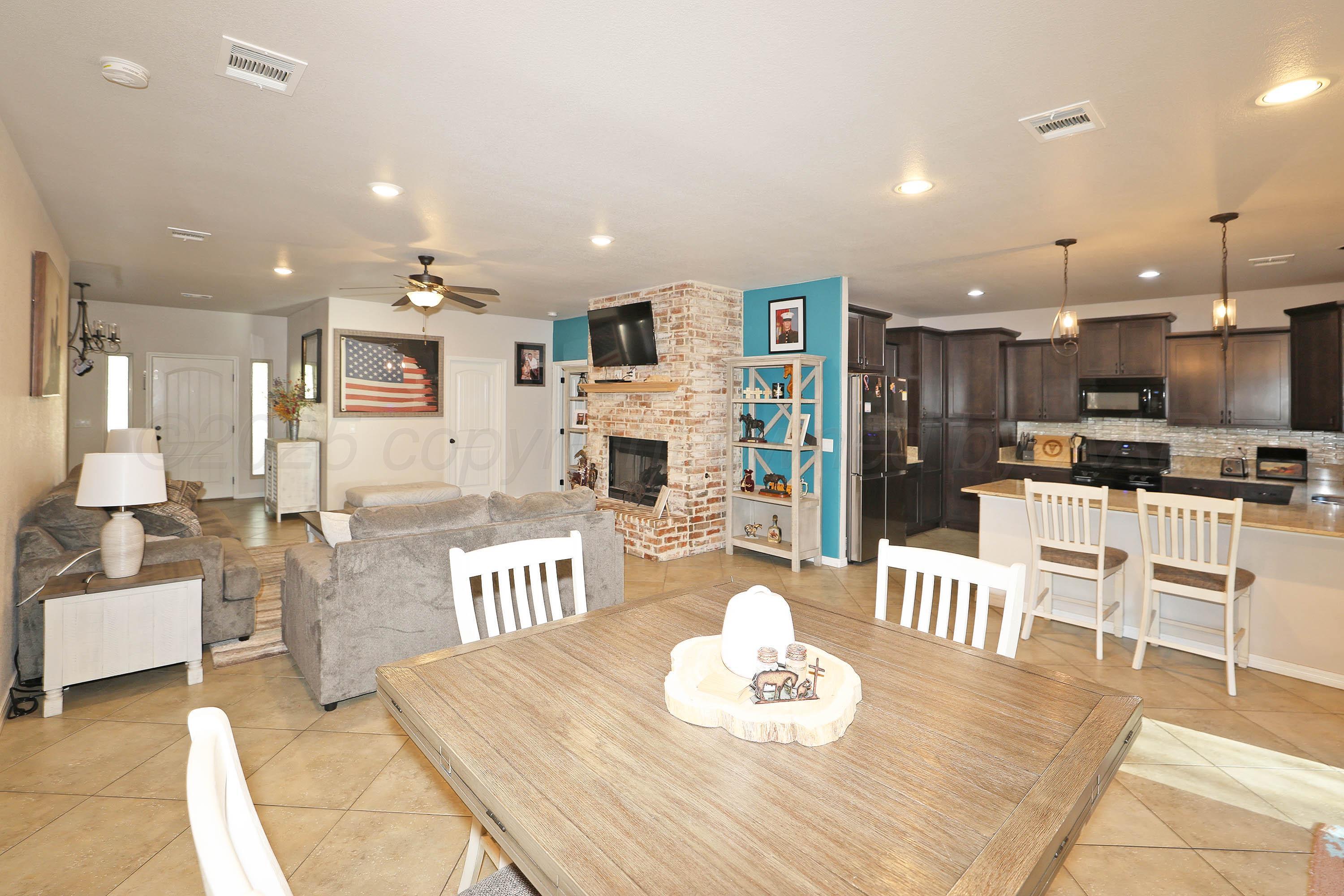 1003 Cabernet Way Amarillo, TX 79124 - Photo 11 of 36 a living room with stainless steel appliances kitchen island granite countertop furniture and kitchen view