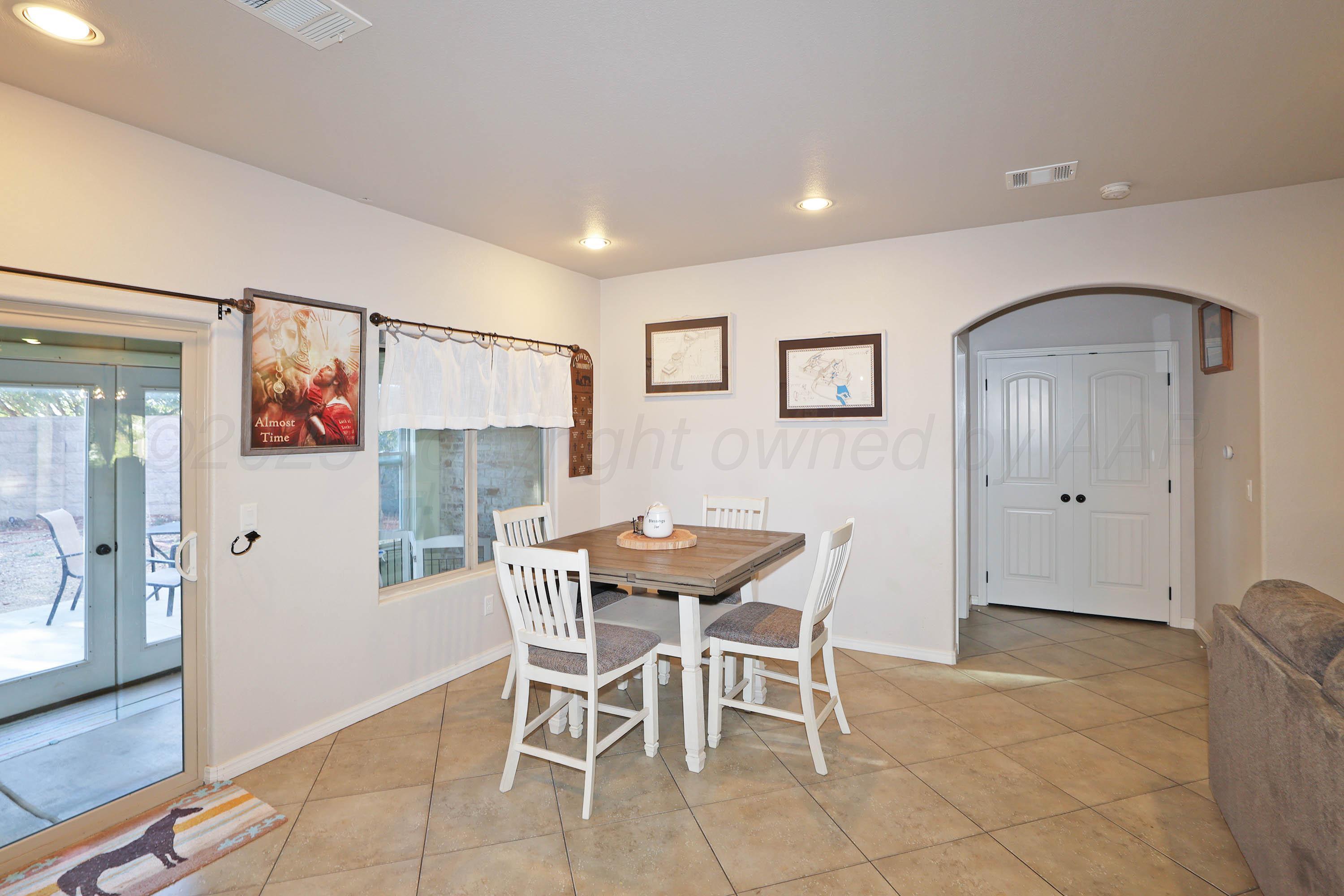 1003 Cabernet Way Amarillo, TX 79124 - Photo 12 of 36 a view of a dining room with furniture and wooden floor