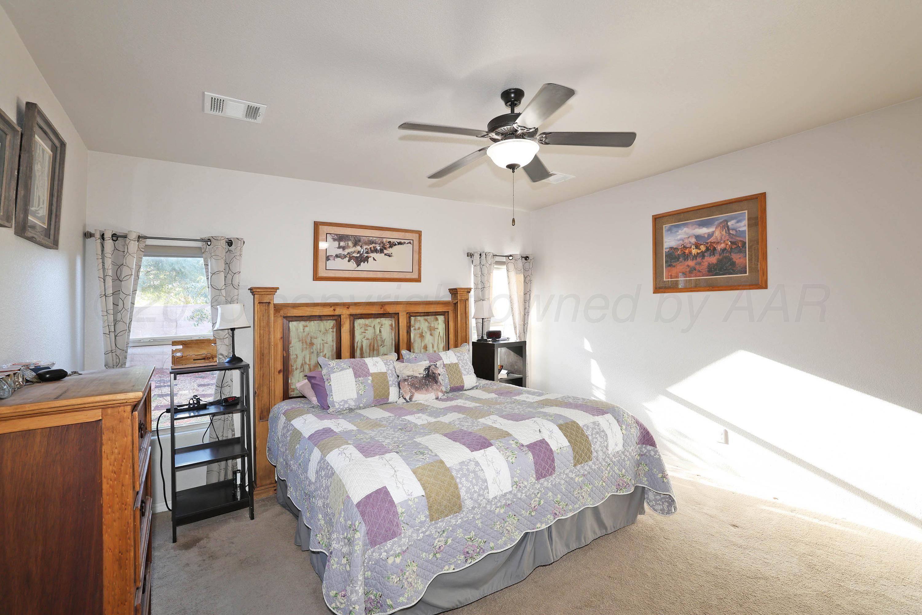 1003 Cabernet Way Amarillo, TX 79124 - Photo 17 of 36 a bedroom with a large bed and a window
