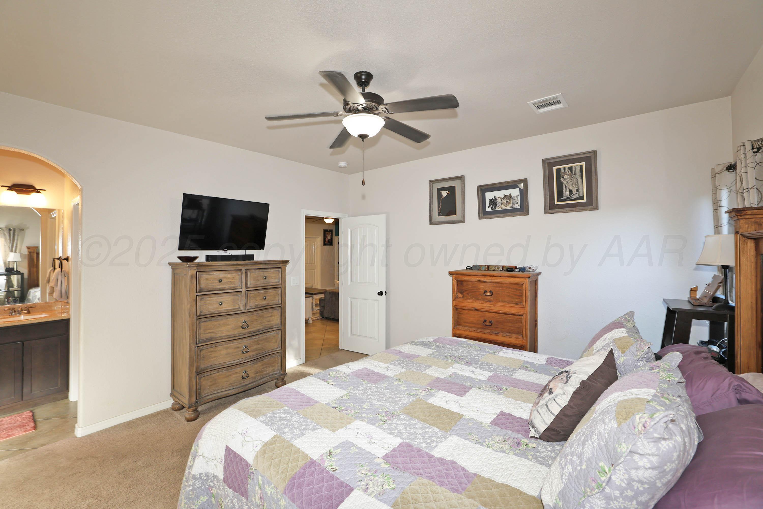 1003 Cabernet Way Amarillo, TX 79124 - Photo 18 of 36 a bedroom with a bed and a television