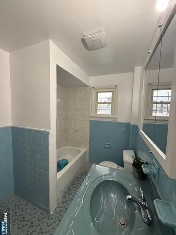 a bath room with a tub and shower