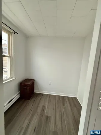 a view of room with wooden floor and window