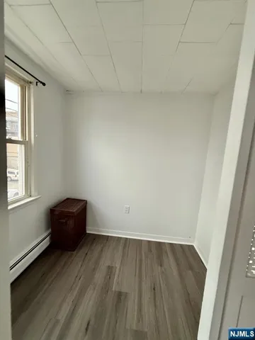 a view of room with wooden floor and window