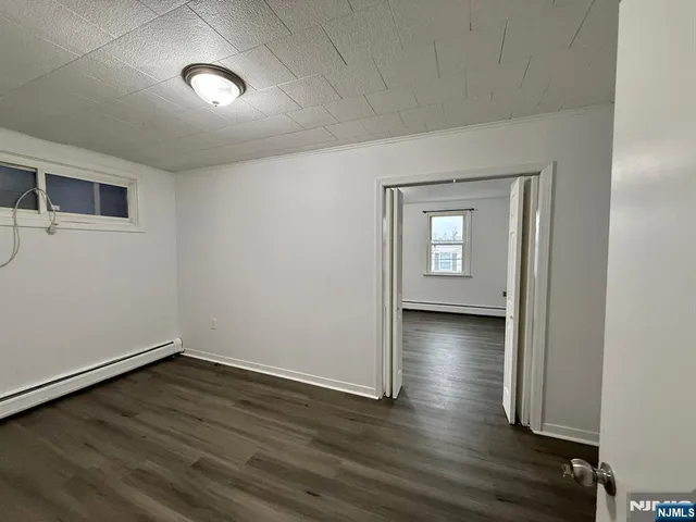 a view of a livingroom with wooden floor and window