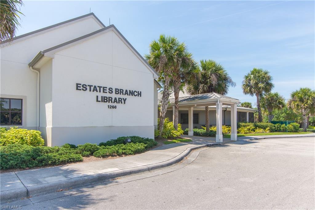 381 22nd Street Northeast Naples, FL 34120 - Photo 17 of 17 a front view of a building with garden