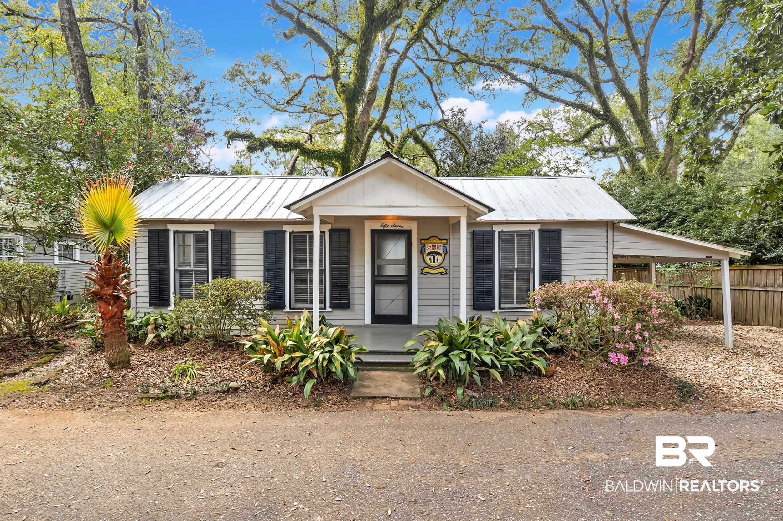 55 Boise Lane Fairhope, AL 36532 - Photo 13 of 24 View of front of house featuring metal roof, a carport, a standing seam roof, and fence