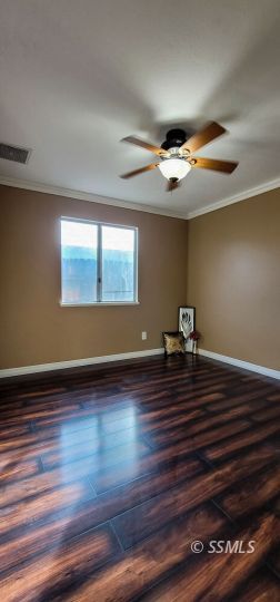 705 Ginger Avenue Ridgecrest, CA 93555 - Photo 10 of 21 a view of room with hardwood floor and ceiling fan