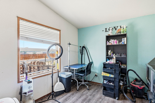 4296 Maple Lane Cedar City, UT 84721 - Photo 23 of 44 Room featuring wood-finish flooring, a window with horizontal blinds, and walls painted in contrasting white and light blue hues