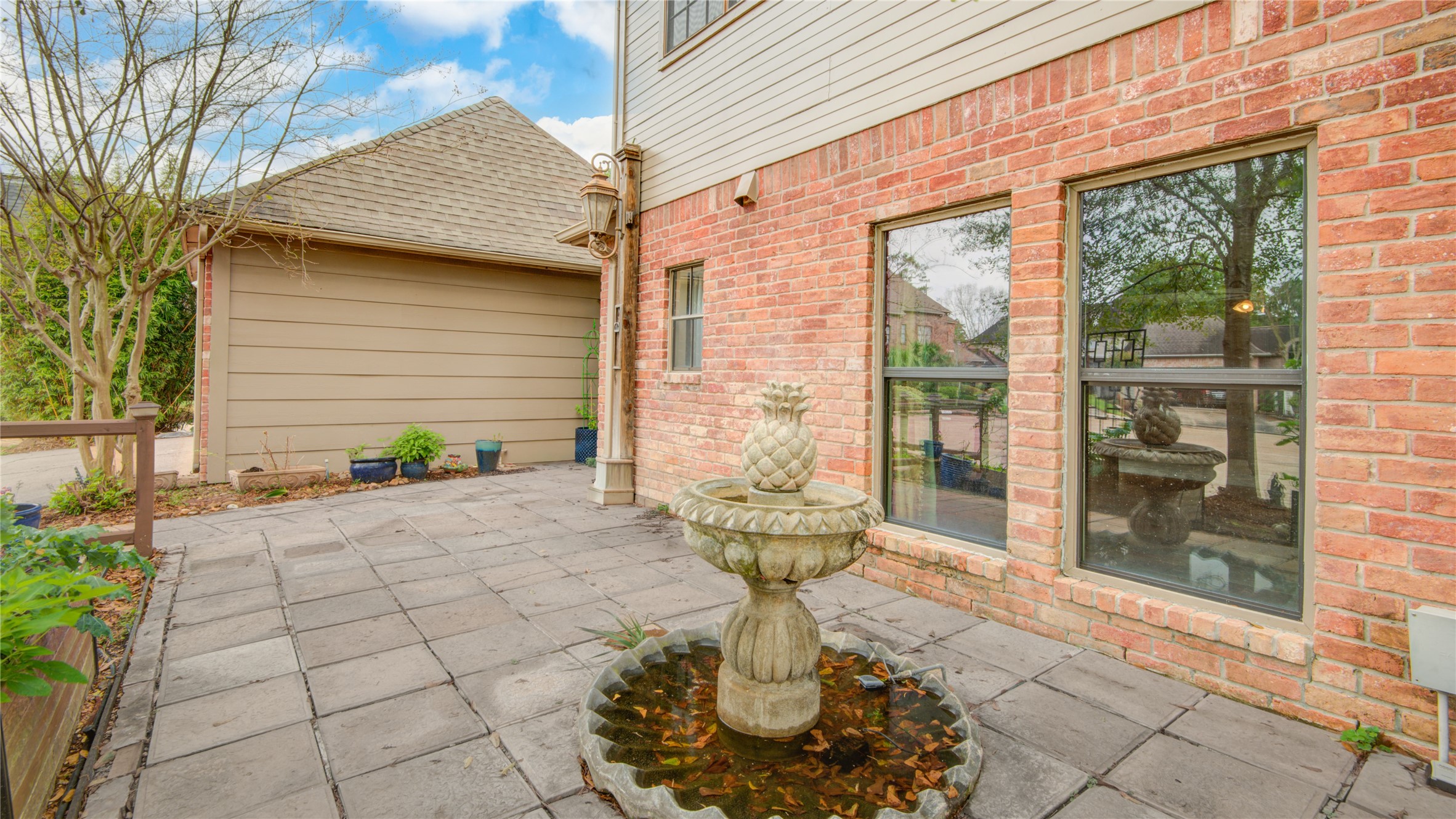 8412 Hidden Trail Lane Spring, TX 77379 - Photo 36 of 43 A tranquil side courtyard welcomes you with a charming fountain and brick-lined patio just outside the breakfast room windows.