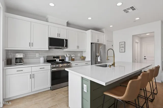 a bed sitting in a spacious bedroom next to a window