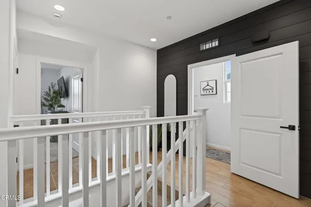 a bedroom with a bed a couch and a potted plant