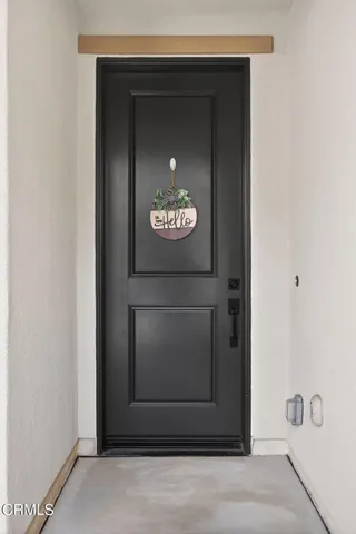 a living room with stainless steel appliances kitchen island granite countertop a dining table chairs kitchen island and couches