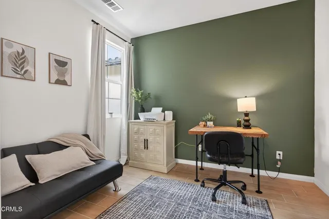 a view of a backyard with plants and outdoor seating