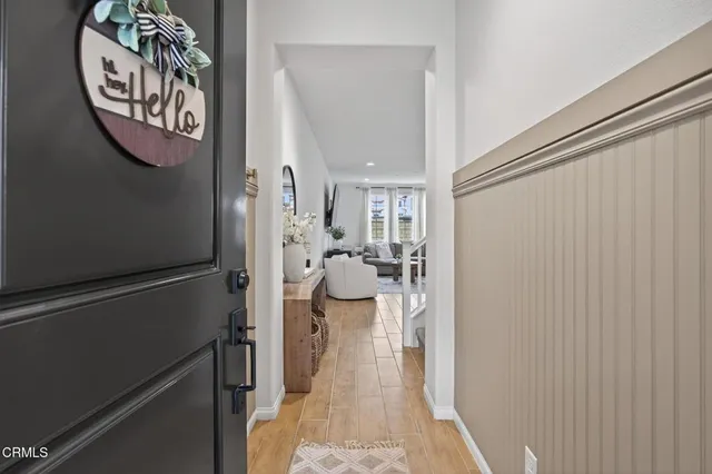 a living room with furniture a flat screen tv and a large window