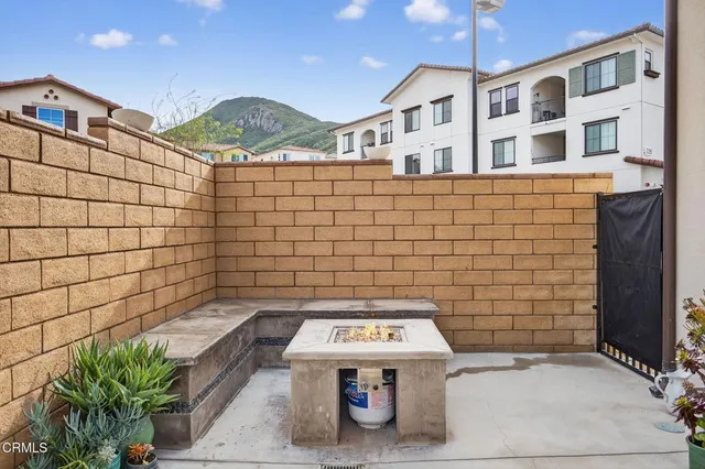 a living room with furniture fireplace and a large window