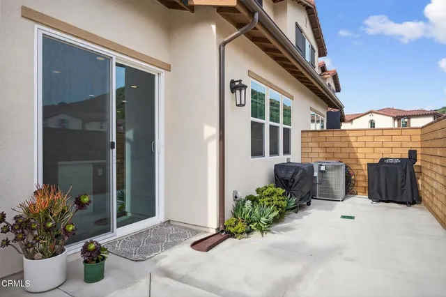 a utility room with stainless steel appliances granite countertop a stove and a sink