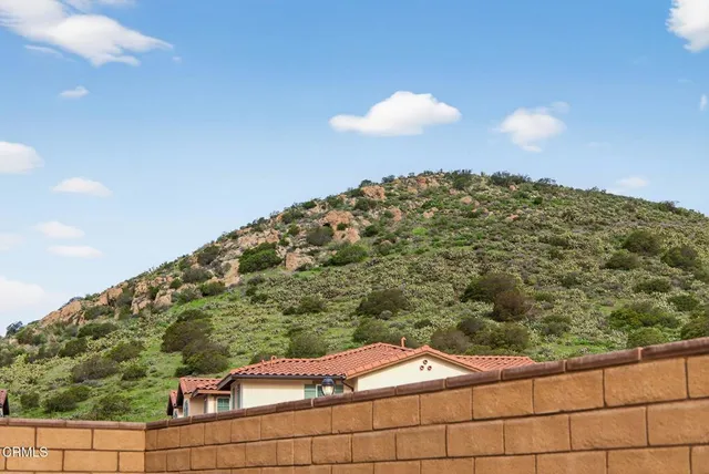 a view of a house with backyard and swimming pool