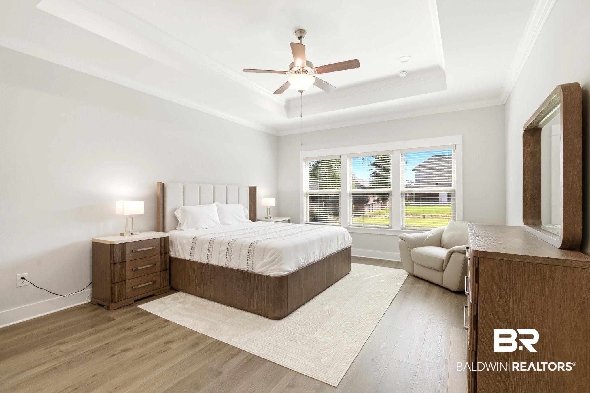 12132 Exbury Way Daphne, AL 36527 - Photo 15 of 47 Bedroom featuring light wood-style floors, a ceiling fan, crown molding, and a tray ceiling