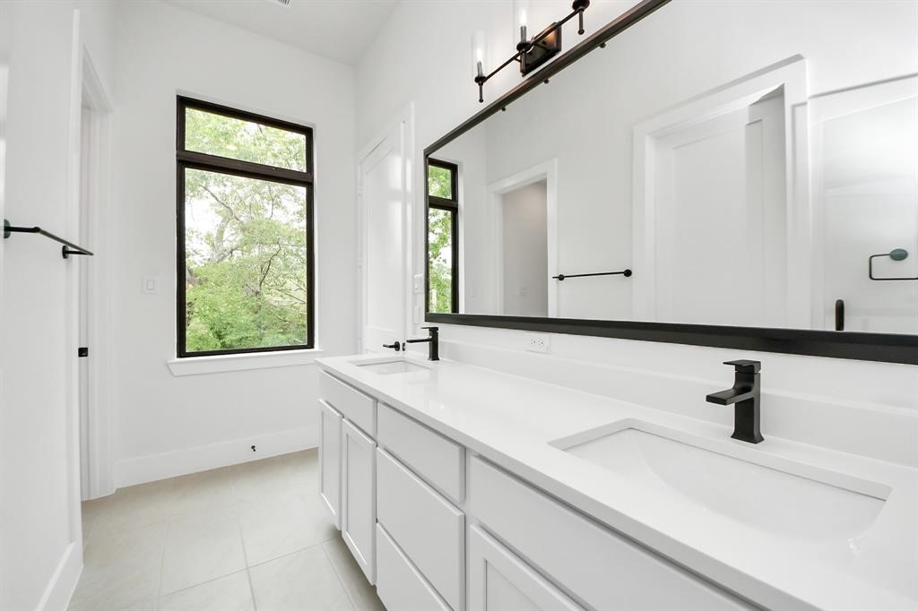 405 Forest Reserve Place Houston, TX 77079 - Photo 24 of 38 Primary bathroom featuring double sinks