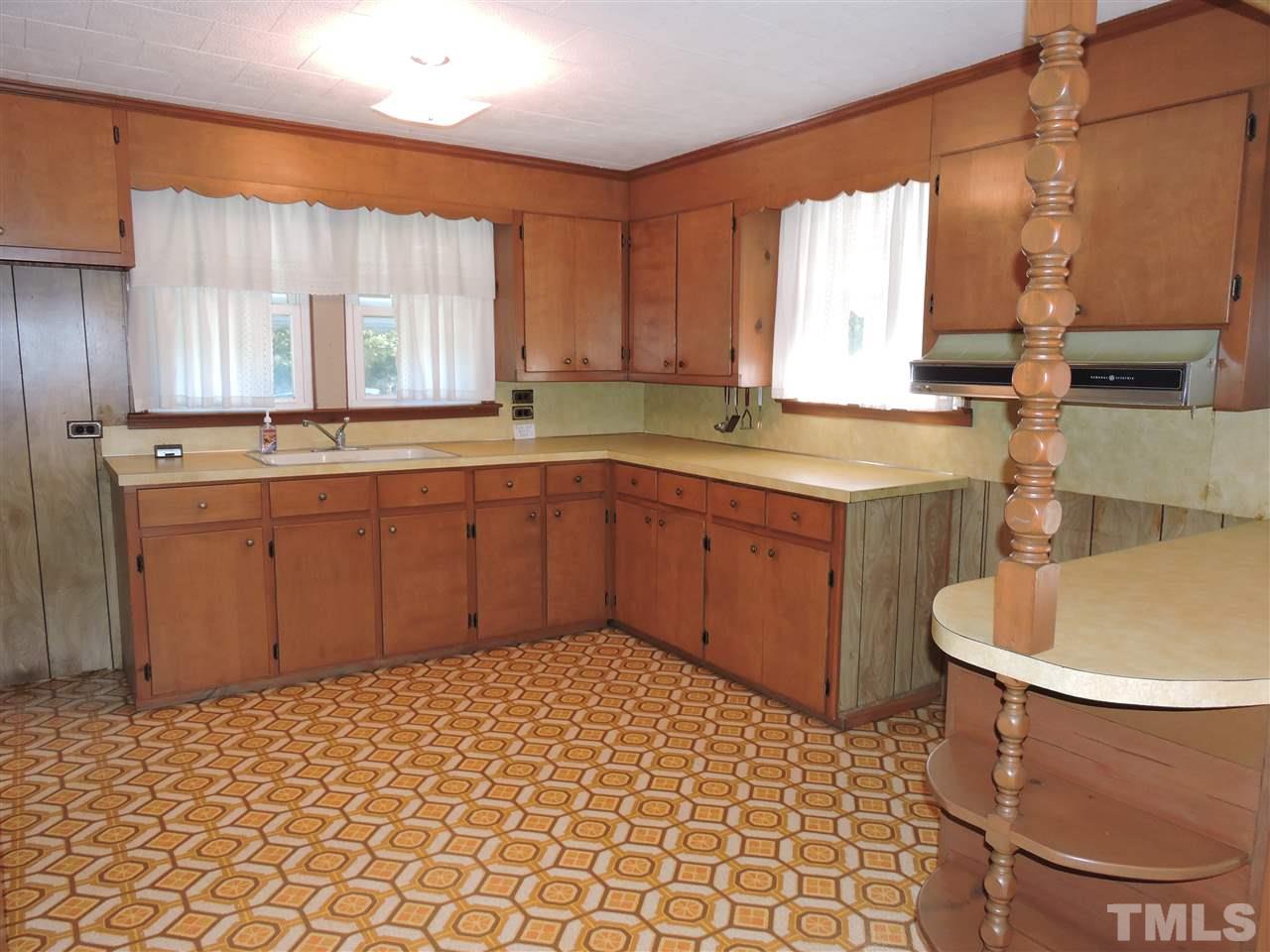216 Red Mountain Road Rougemont, NC 27572 - Photo 5 of 7 a kitchen with a sink a stove cabinets and a dining table