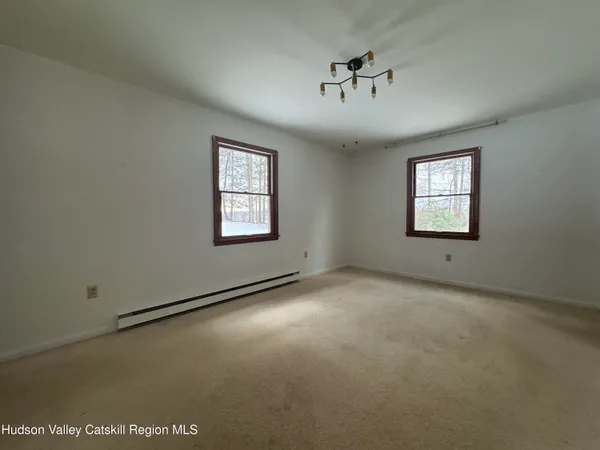 an empty room with windows and closet