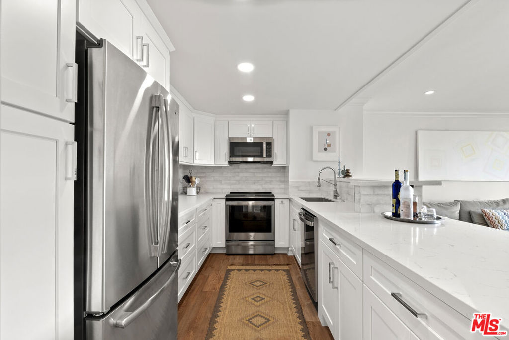 2160 Century Hill, Unit 910 Los Angeles, CA 90067 - Photo 4 of 20 a kitchen with stainless steel appliances a stove sink and refrigerator