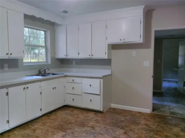 a bathroom with sink and window
