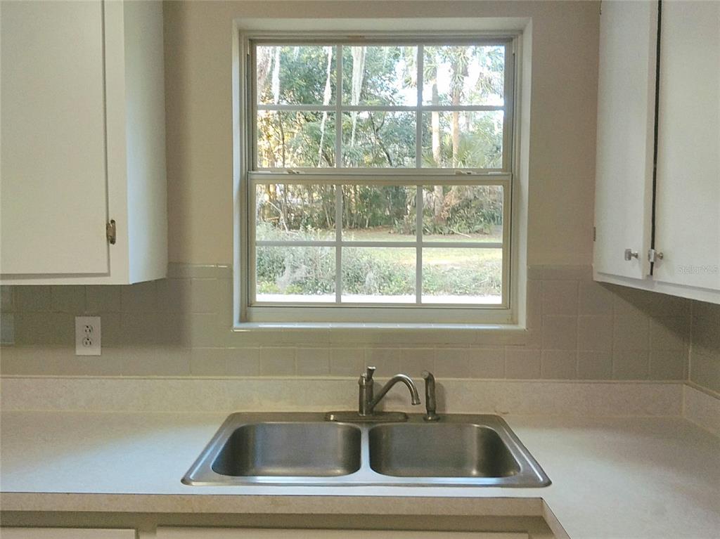 487 Rylane Street De Leon Springs, FL 32130 - Photo 15 of 40 a bathroom with sink and window