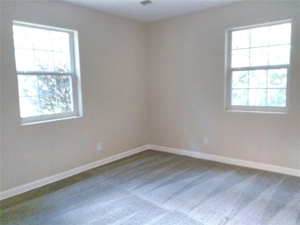 487 Rylane Street De Leon Springs, FL 32130 - Photo 18 of 40 an empty room with a window