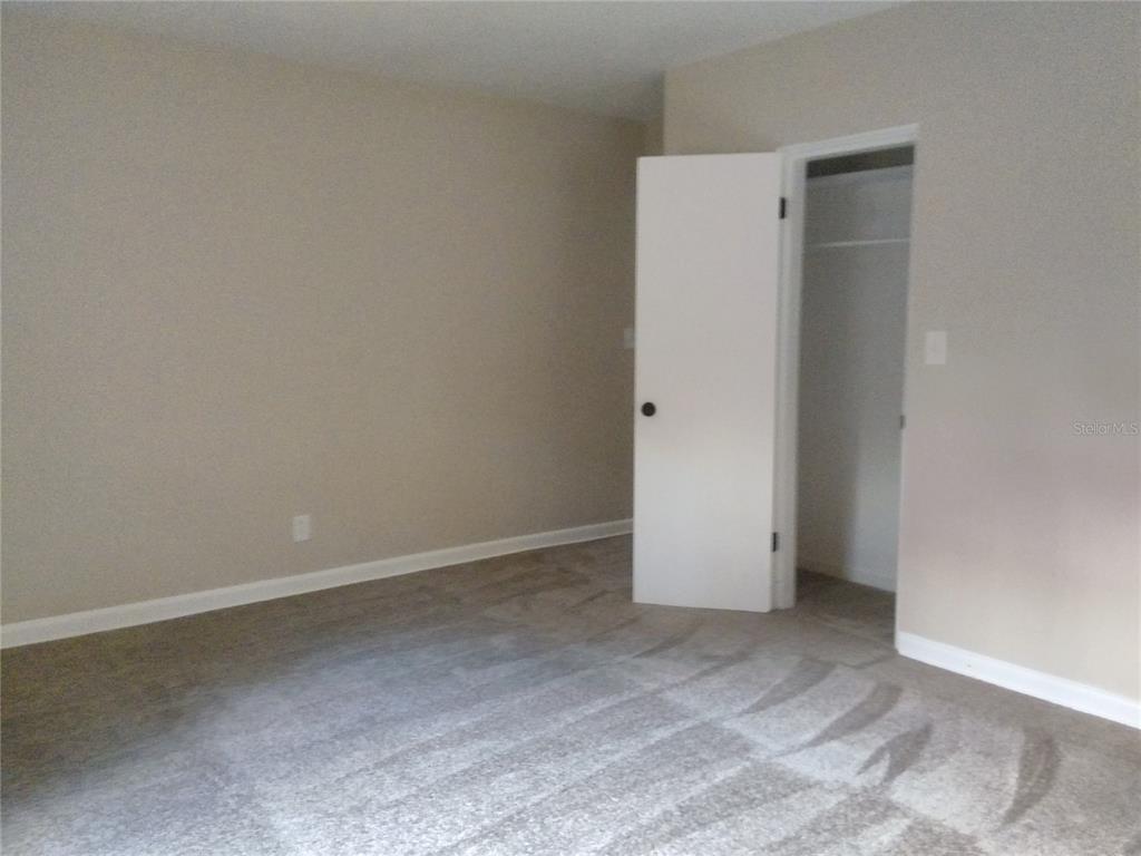 487 Rylane Street De Leon Springs, FL 32130 - Photo 19 of 40 an empty room with closet